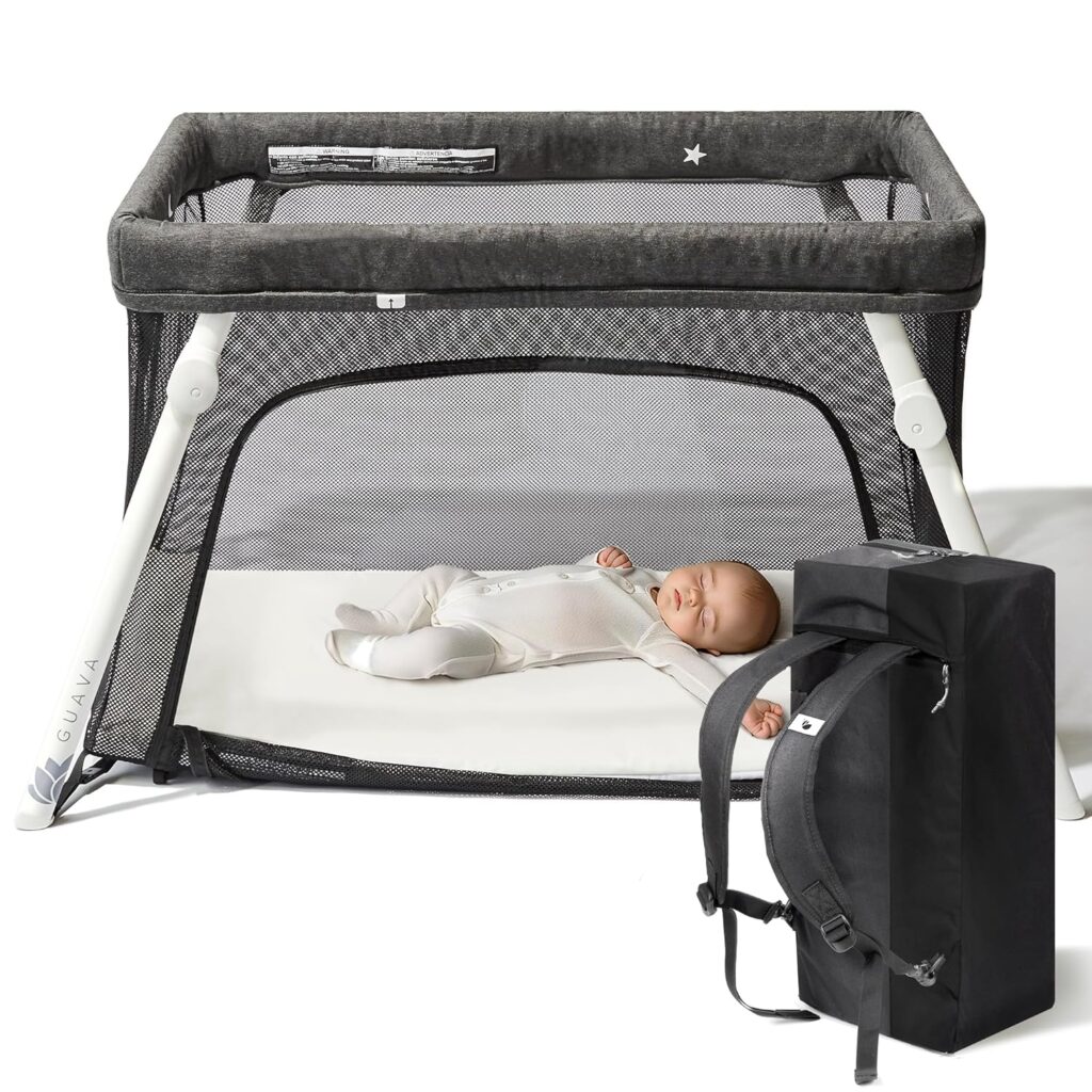 Best Travel Crib for Toddlers in 2026 Guava Family Lotus Travel Crib with sleeping baby and included backpack carrying case.