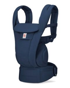 A dark blue soft-structured baby carrier with padded shoulder straps and a wide waistband, standing upright on a white background.