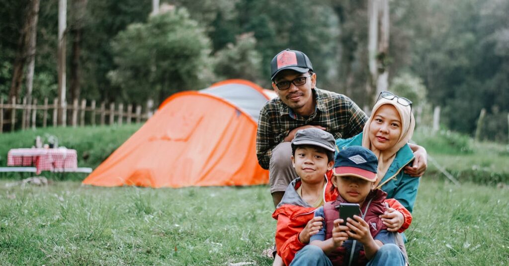 Happy family enjoying a relaxing camping trip in a lush forest setting, perfect for outdoor enthusiast inspiration.